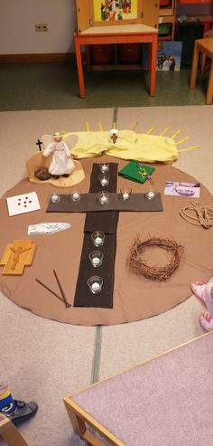 a table with various items on it in the middle of a playroom area,