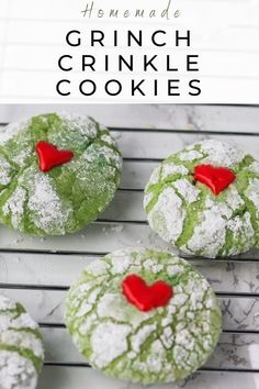 green crinkle cookies on a cooling rack with powdered sugar and red heart