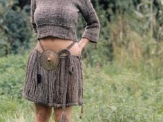 a woman wearing a skirt and holding a frisbee