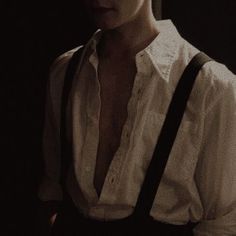 a man wearing suspenders and a white shirt