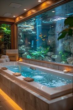 a large fish tank in the middle of a bathroom with a jacuzzi tub