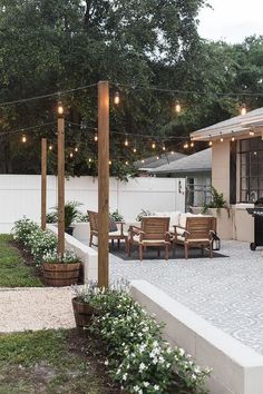 an outdoor patio with string lights and chairs