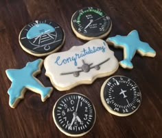 some cookies are decorated with different types of clocks and weather vanens on a table