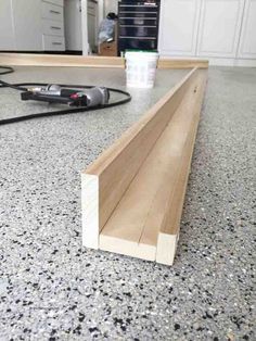 a close up of a counter top with a cup on the floor next to it