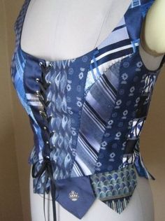 a mannequin wearing a blue and white top with ties on it's chest