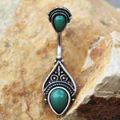 • Navel Ring / Belly Button Ring with a Victorian design• Ornate Design top with Synthetic Green Stones• Two (2) teardrop shaped Green Stones• Jewelry is partially plated in black for an antique look• Bar Thickness : 14GA | 1.6mm• Bar Length : 3/8" | 10mm• Total Jewelry Size : 12mm x 36mm• Material : 316L Stainless Steel, Zinc Alloy, Synthetic Green Stone Belly Piercing Jewelry Boho, Belly Button Rings Emerald, Cute Belly Rings, Green Stone Jewelry, Bellybutton Piercings, Belly Button Piercing Jewelry, Belly Piercing Jewelry, Gold Arrow, Rings Etsy