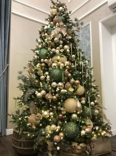 a christmas tree decorated with gold and silver ornaments