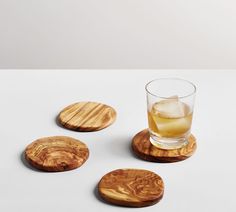 four wooden coasters with drinks in them