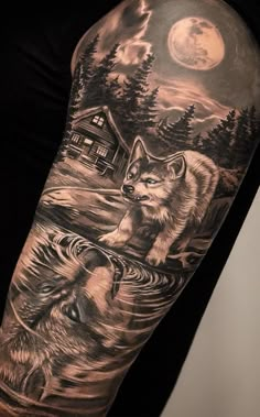 a man's arm with an image of two wolfs and a cabin in the background