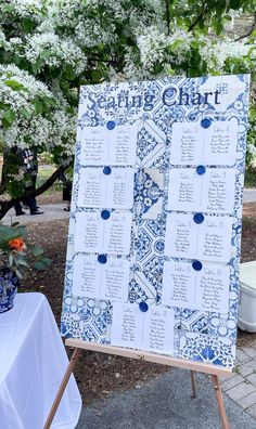 a blue and white wedding seating chart on an easel