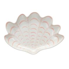 a white and pink shell shaped dish on a white background with an orange stripe in the center