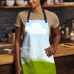 a woman standing in front of a counter wearing an apron