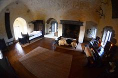 a living room filled with furniture and a fire place in the middle of a room