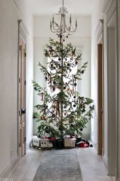 a christmas tree in the middle of a hallway