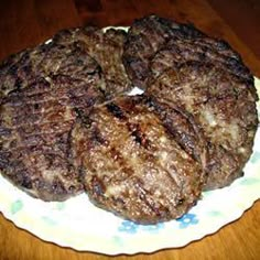 the steak has been cut into pieces and served on a white plate with yellow flowers