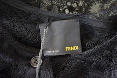 Guaranteed authentic Fendi luscious black lace blouse. Stunning black lace button down top with sleeves that are slit open along the outside.Fabric wraps and twists at the wrist to create a soft puff.Black spaghetti strap camosile goes underneath.NEW or NEVER WORN. Tags attached. Please note: have the matching gray trouser with lace inset running down the leg.final saleSIZE 42USA SIZE fits 6 to 8TOP MEASURES: LENGTH 24.5"UNDERARM TO UNDERARM 20.5"WAIST 19"HIP 20"SLEEVE 22.5"CAMISOLE MEASURES:LEN Fendi Blouse, Top With Sleeves, Black Spaghetti, Black Spaghetti Strap, Black Lace Blouse, Lace Button, Grey Trousers, Lace Inset, Lace Blouse