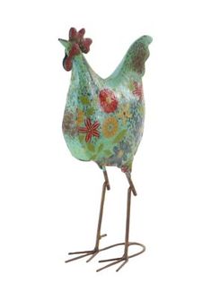 a metal rooster with flowers painted on it's body and legs, standing in front of a white background