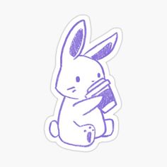 a purple sticker with an image of a rabbit holding a book in it's lap