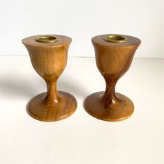 two wooden candlesticks sitting next to each other