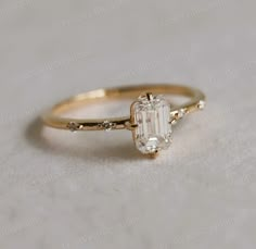 a gold ring with an oval cut diamond