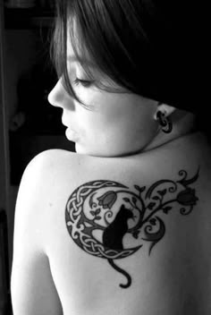 a woman with a cat tattoo on her upper back shoulder and neck, in black and white