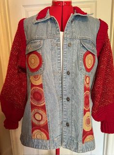 a jean jacket with red sleeves and circles on it