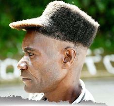 a close up of a person with a hat on his head and trees in the background