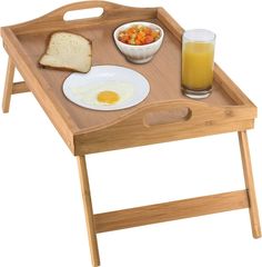 a wooden tray with breakfast food on it