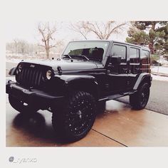 a black jeep parked on the side of a road