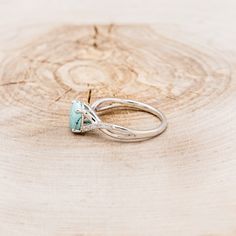 a close up of a ring on a piece of wood