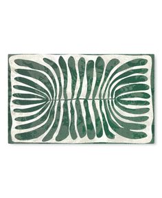 a green and white rug with an abstract design on the bottom, in front of a white background