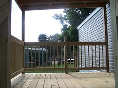 an open door on a wooden deck leading to a back yard