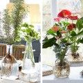 three different vases with flowers in them sitting on a table