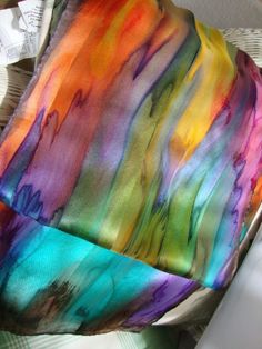 a multicolored scarf sitting on top of a table