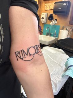 a man with a tattoo on his arm that reads run your life in cursive writing