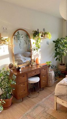 a bedroom with potted plants and a mirror