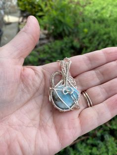 Triangular Larimar stone, wire wrapped in silver plated wire. Woven bail and frame holds this lovely larimar in place. Comes with a free chain. Larimar Stone, Wrapped Pendant, Wire Wrapped Pendant, Wire Wrapped Jewelry, Alex And Ani Charm Bracelet, Wire Wrapped, Wire Wrapping, Silver Plate, Silver Plated