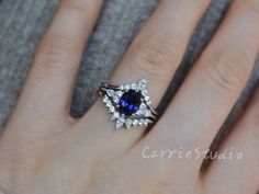 a woman's hand with a blue and white ring on top of her finger