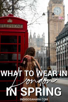 a woman standing in front of a red phone booth with the words what to wear in london in spring