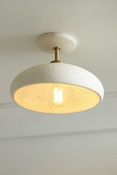 a white light fixture hanging from the ceiling