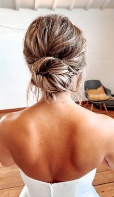 the back of a woman's head wearing a white dress