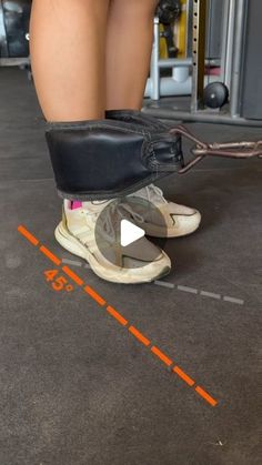 a person standing on top of a pair of shoes in a gym floor next to a machine