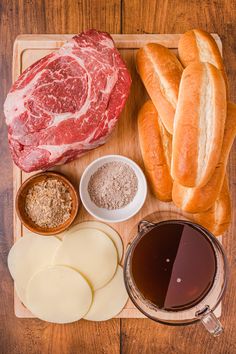 meat, bread and other ingredients on a cutting board