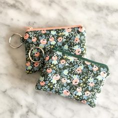 two zippered pouches sitting on top of a marble counter