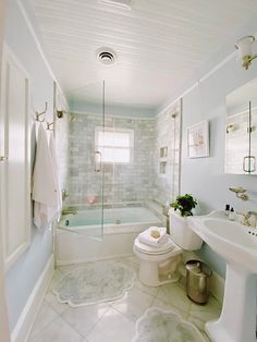 a bathroom with a toilet, sink and bathtub