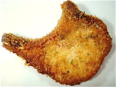 a fried fish fillet on a white surface