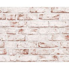 an old brick wall with white paint