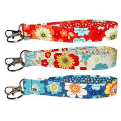 three dog leashes with flowers on them, one is red and the other is blue