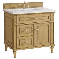 a bathroom vanity with white marble top and wooden cabinetry on the bottom, along with two faucets