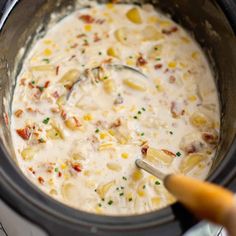 a spoon in a pot filled with food